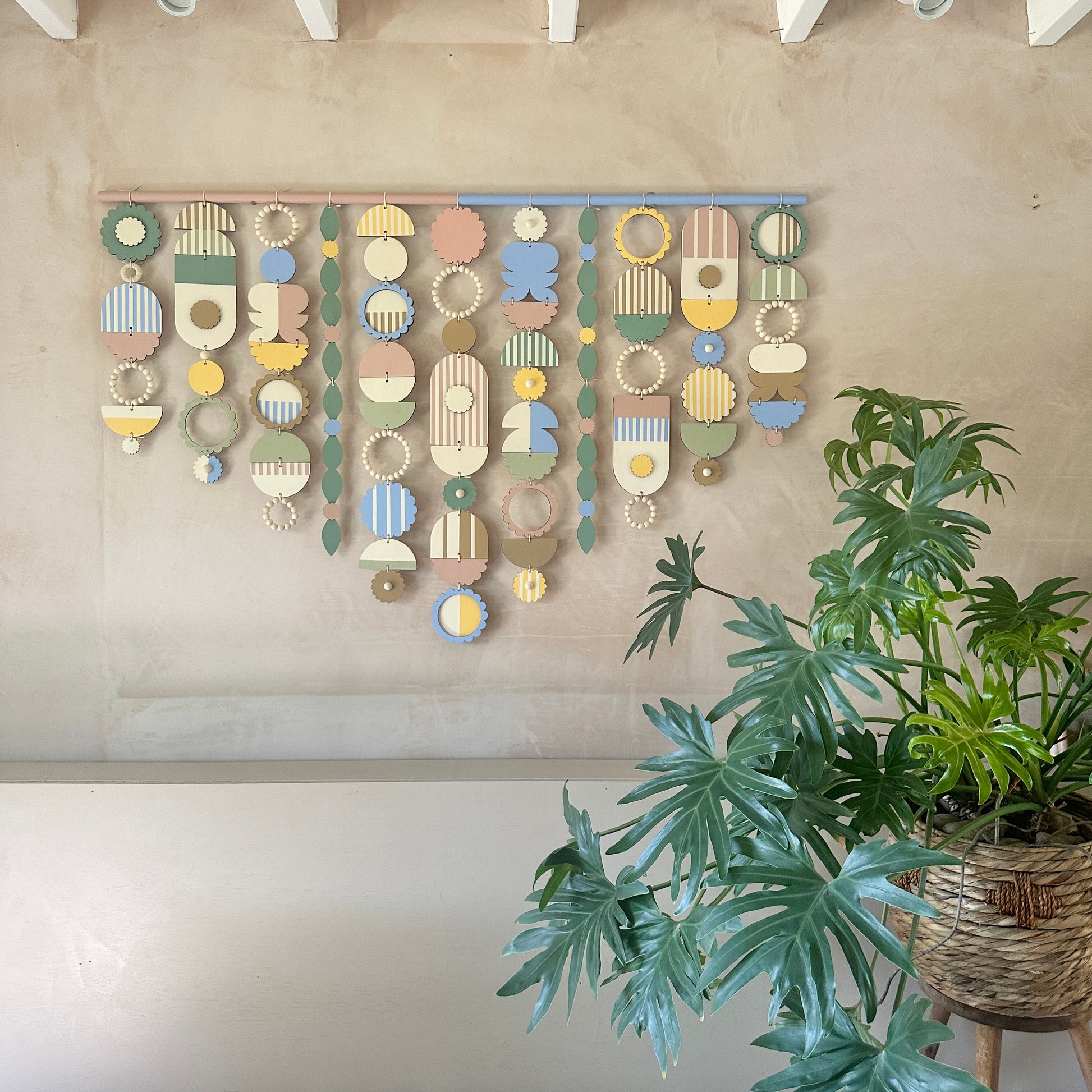 A vibrant wall hanging featuring an array of colorful geometric shapes in various sizes and patterns.