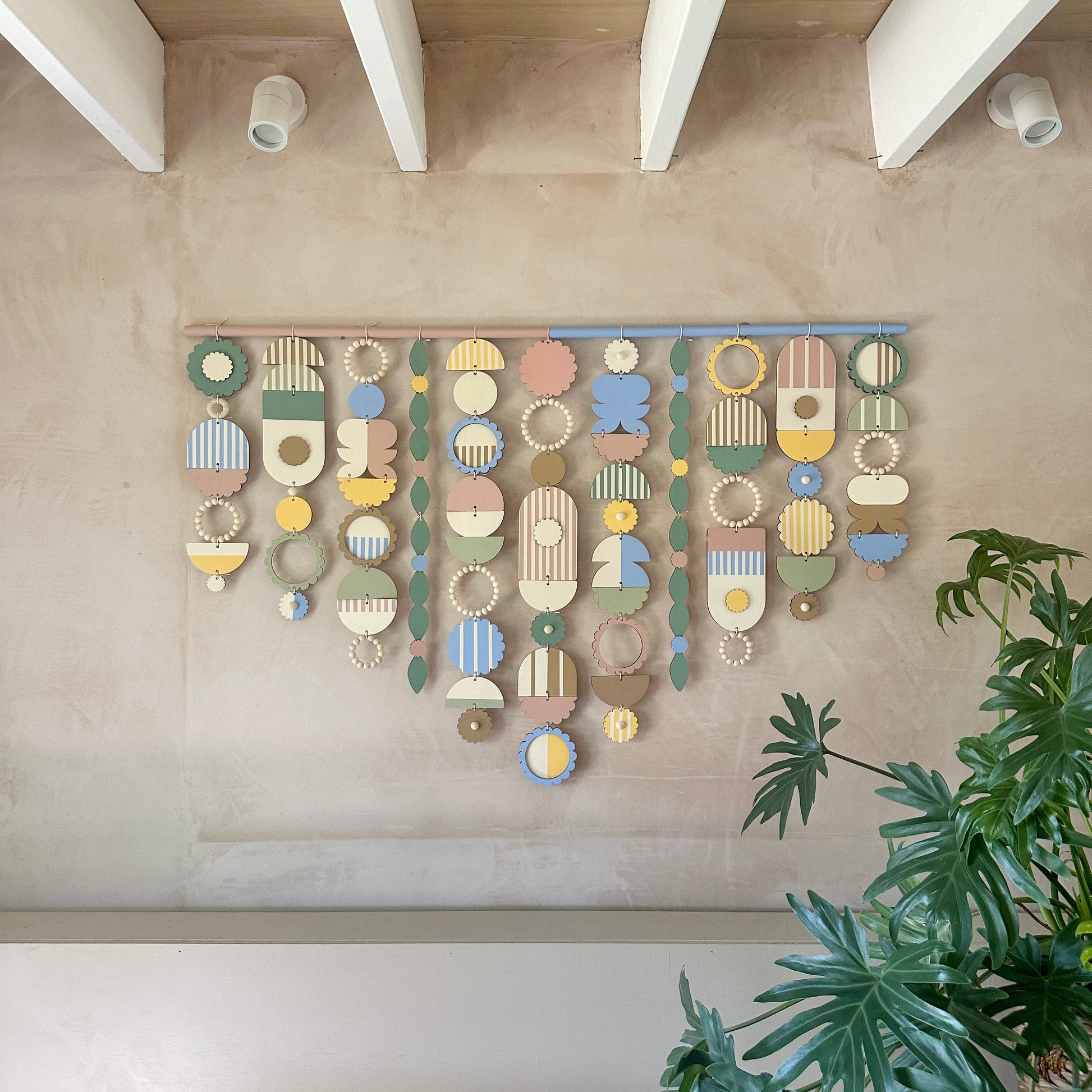 A stunning wall hanging displaying a variety of colorful geometric shapes, creating a playful and artistic atmosphere.