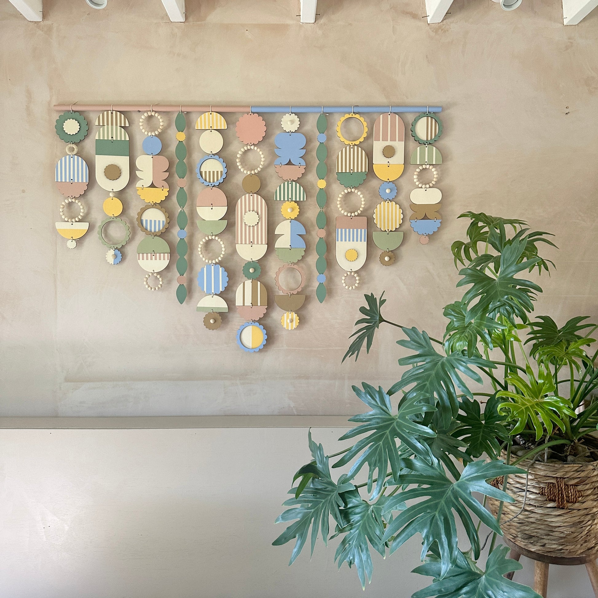 A vibrant wall hanging featuring an array of colorful geometric shapes in various sizes and patterns.  