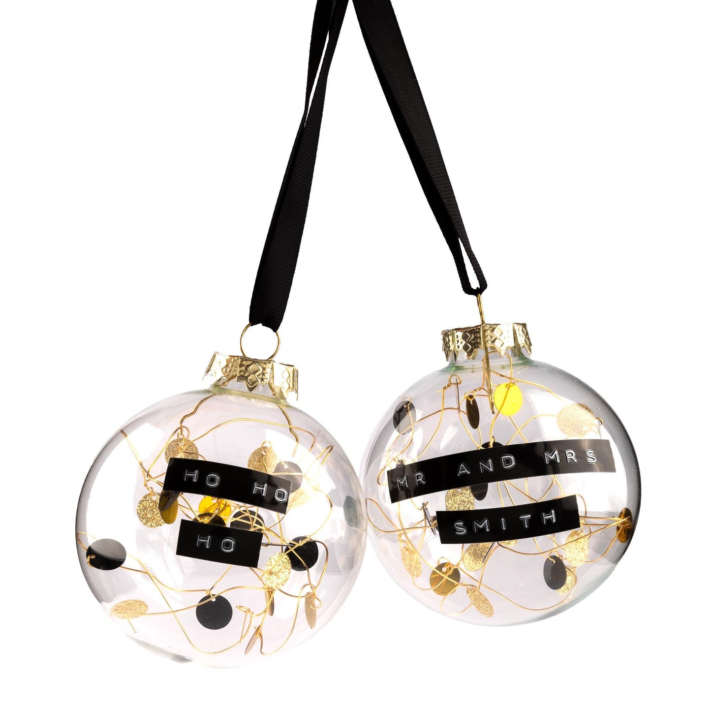 Glass baubles with gold, glitter gold and black sequins on gold wire inside with a black ribbon to hang it from. With a personalised message embossed on black tape.